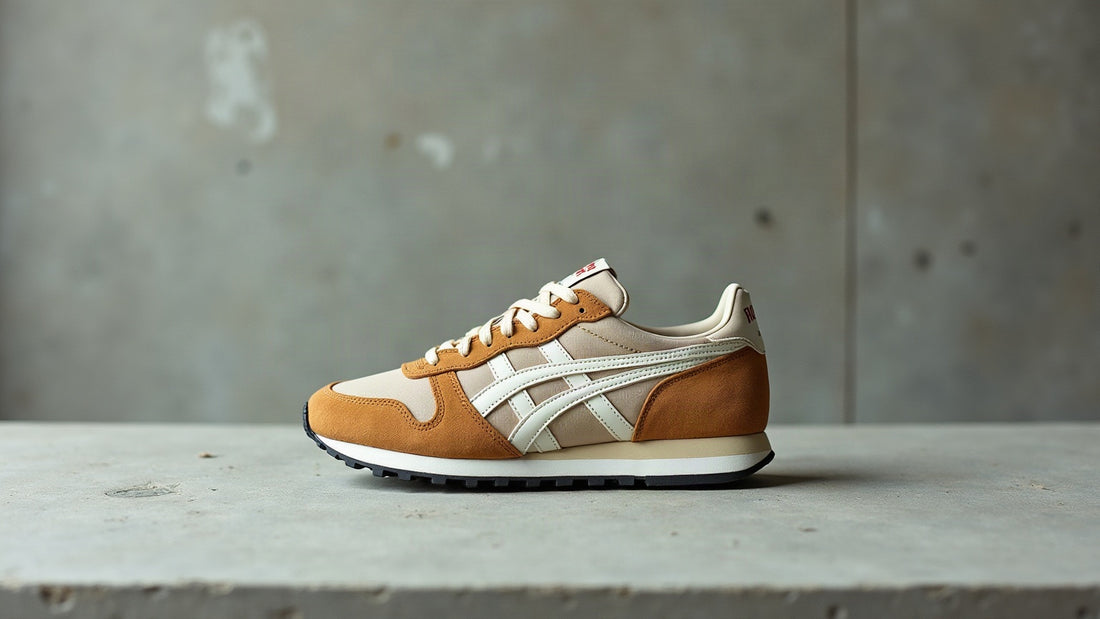 Side profile of a camel suede and ecru mesh 80s retro runner sneaker on grey concrete in overcast daylight.