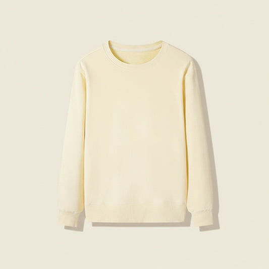 Relaxed ivory loopback cotton crewneck sweatshirt with ribbed collar, cuffs and hem, styled with taupe tailored trousers.