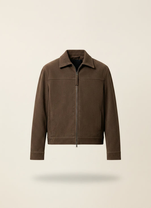 Cropped taupe zip-front jacket styled over a black top and stone tailored trousers, soft daylight studio.