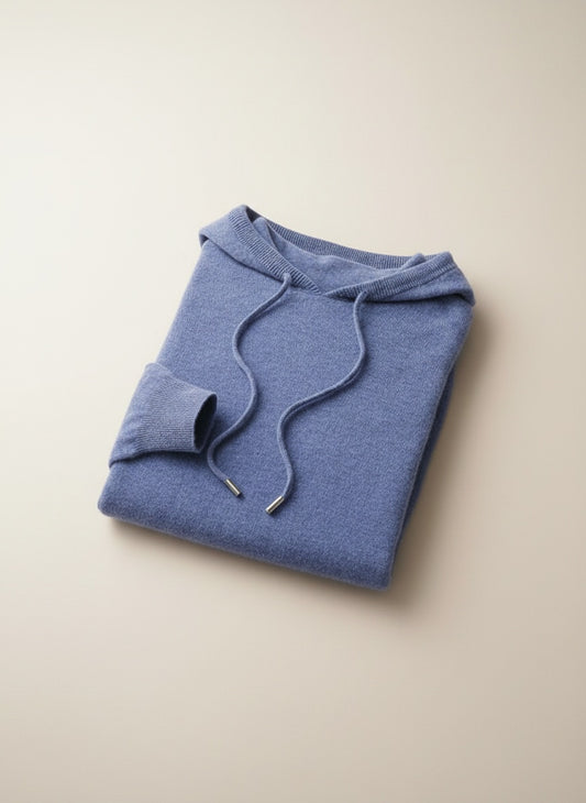 Dusty cornflower-blue strapless knit top styled with taupe high-waisted trousers in soft warm daylight.