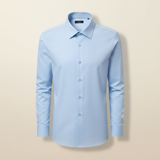 Pale sky-blue wool-blend shirt with spread collar and tonal buttons, styled with neutral trousers against a warm off-white plaster backdrop.
