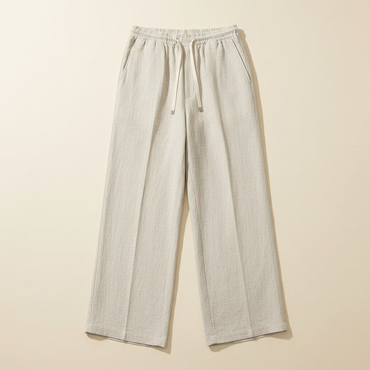 Ivory pure linen wide-leg drawstring trousers styled with a ribbed tank, soft studio light, quiet-luxury summer edit.