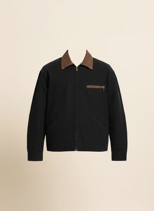 Black Detroit-style jacket with tobacco corduroy collar, chest zip pocket and leather pull, styled with stone trousers.