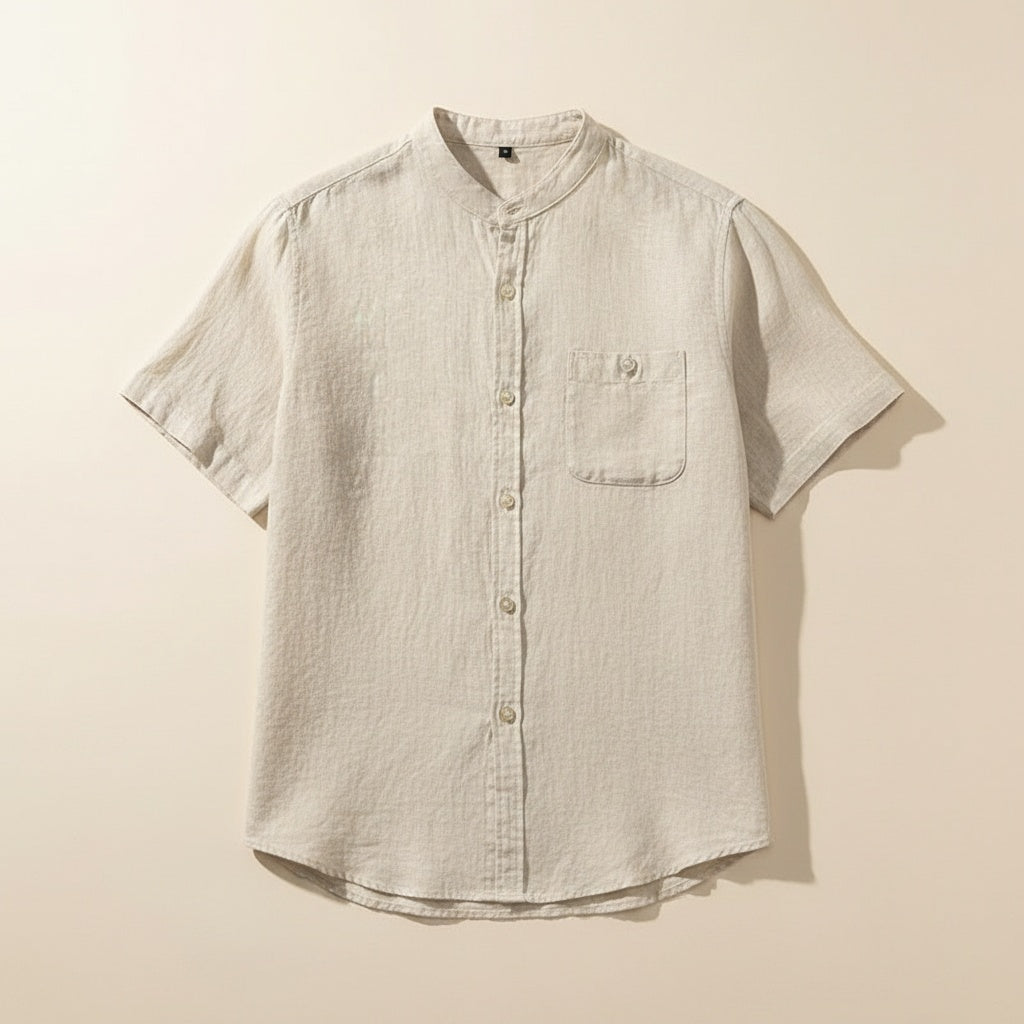 Ivory mandarin-collar short-sleeve shirt with tonal buttons and chest pocket, styled with stone wide-leg trousers.