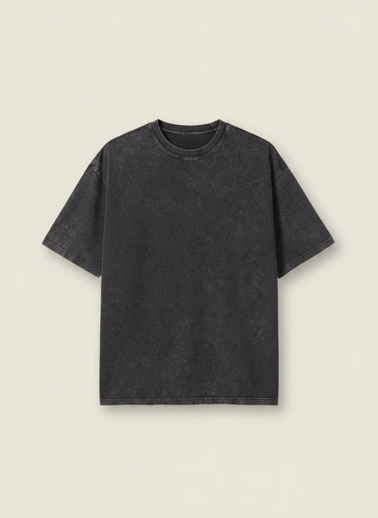Washed charcoal heavyweight cotton tee with relaxed drop-shoulder cut and ribbed crew neck, styled with stone tailored trousers.