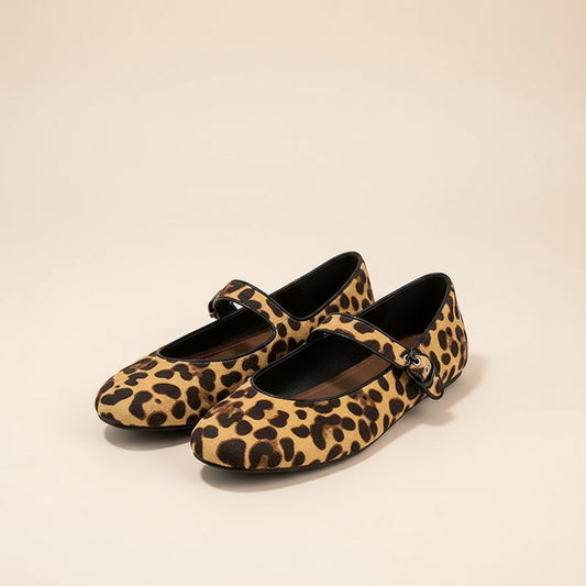 Leopard-print calf hair Mary Jane ballet flats with slim strap and round toe, styled in warm sunlit light.