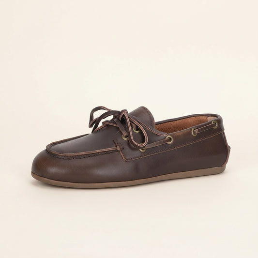 Dark brown leather boat shoe moccasin with hand-stitched moc-toe, rawhide laces, brass eyelets and low gum sole.