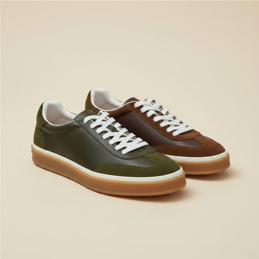 Heritage low-top trainers with suede and leather panels, white laces and honey-gum cup sole on warm off-white studio backdrop.