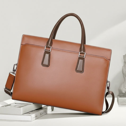 Structured tan leather attaché briefcase with twin rolled handles and silver hardware, styled on a warm neutral studio background.